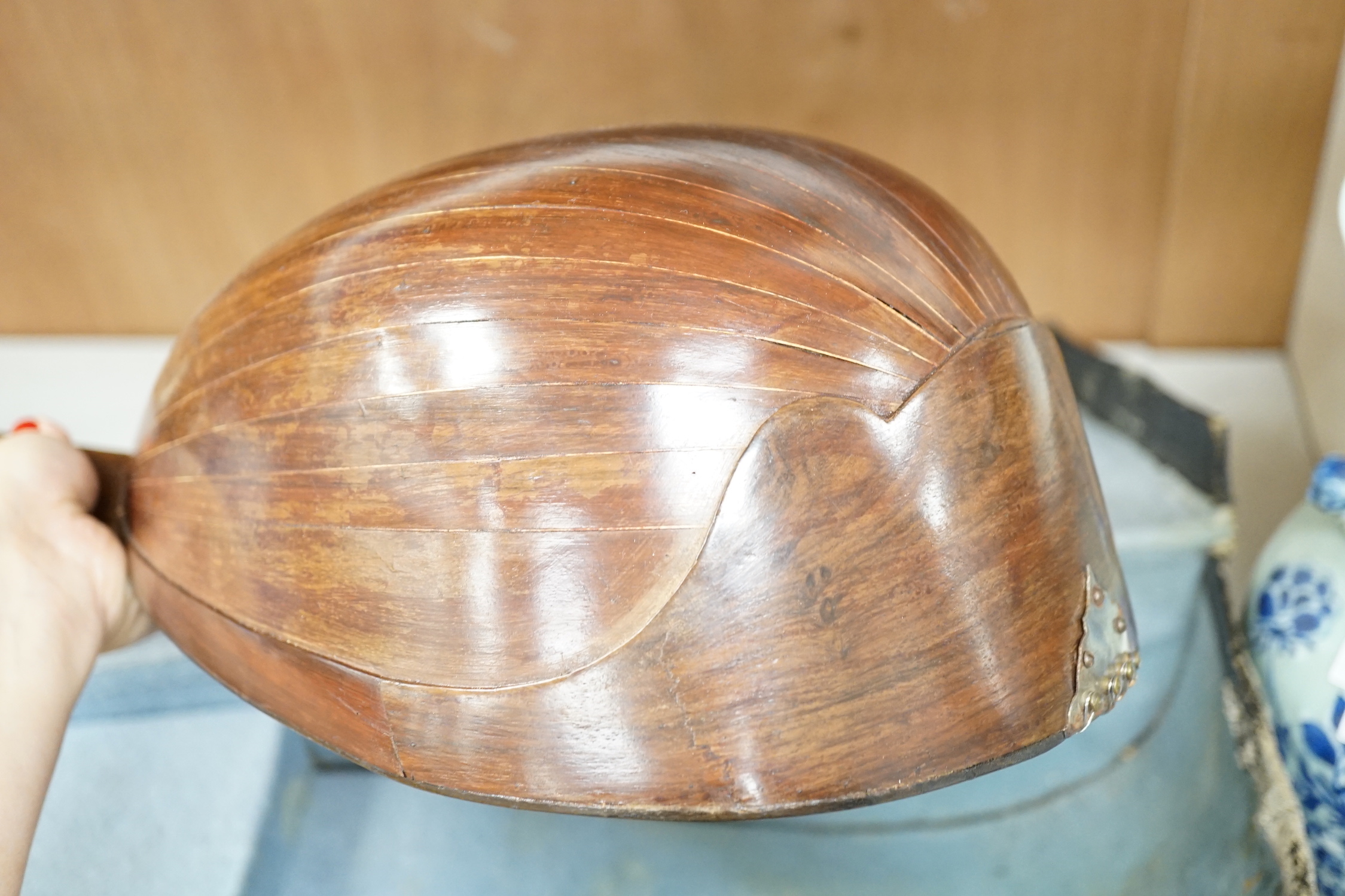 A cased mandolin with tortoiseshell detail, bone tuning pegs, 61cm long